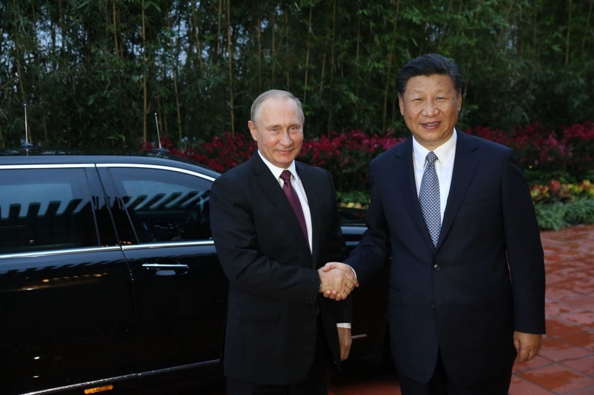 Russian President Vladimir Putin (L) shakes hands with Chinese President Xi Jinping (R) during his meeting on September 3, 2017 in Xiamen, China.