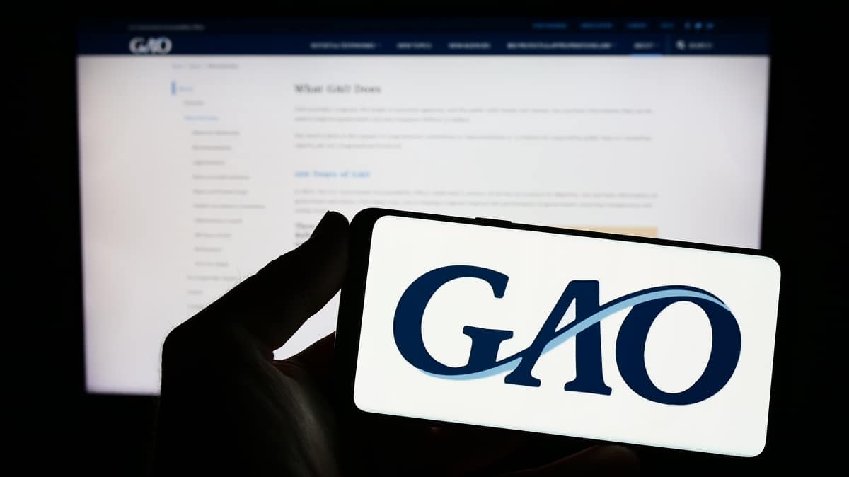 Stuttgart, Germany - 04-23-2023: Person holding smartphone with logo of US Government Accountability Office (GAO) on screen in front of website. Focus on phone display. Unmodified photo.