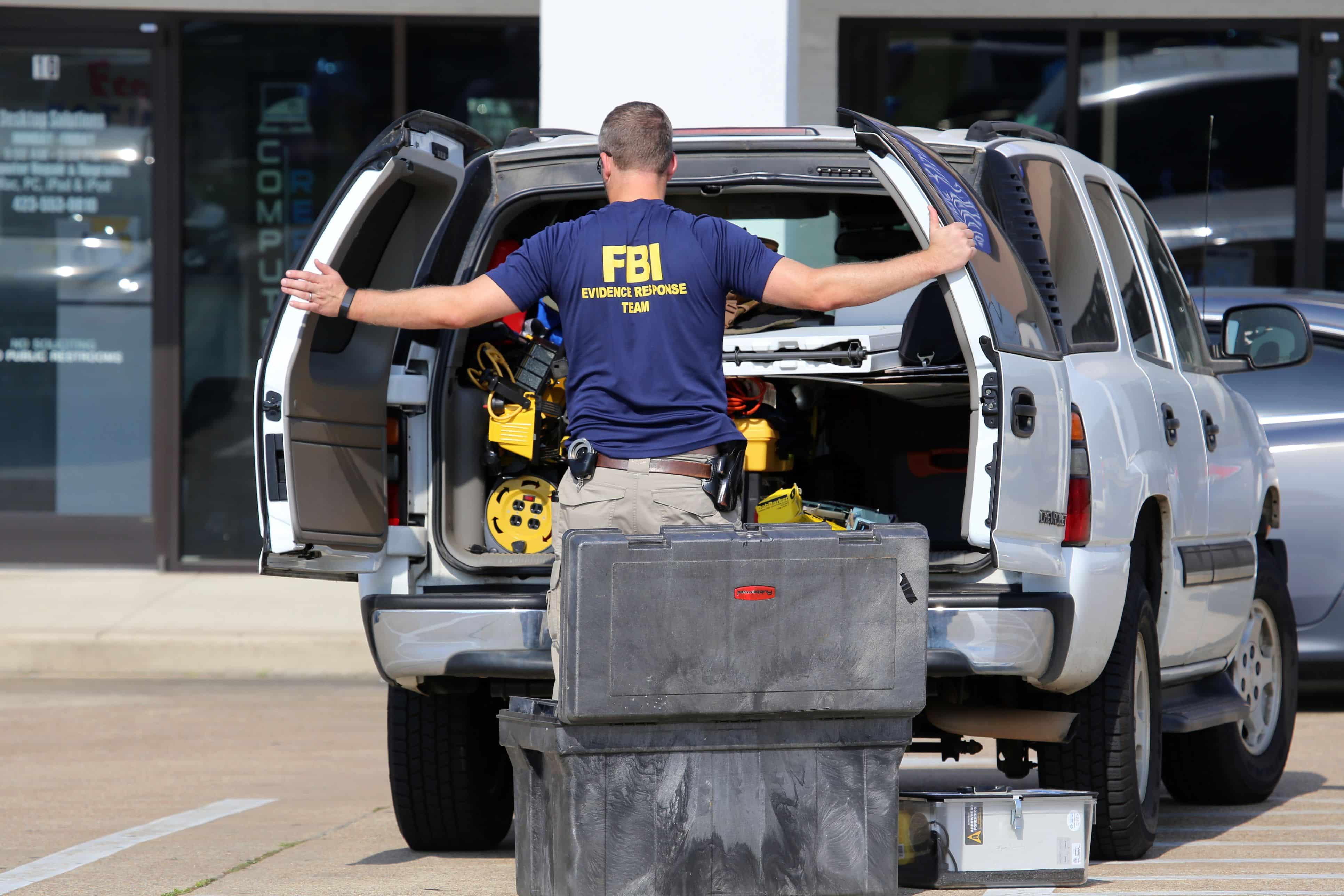 CHATTANOOGA, TN/USA - JULY 18: An FBI agent gathers evidence at the Armed Forces Career Center in Chattanooga, TN on July 18, 2015. An attack on the center was carried out on July 16th, 2015.