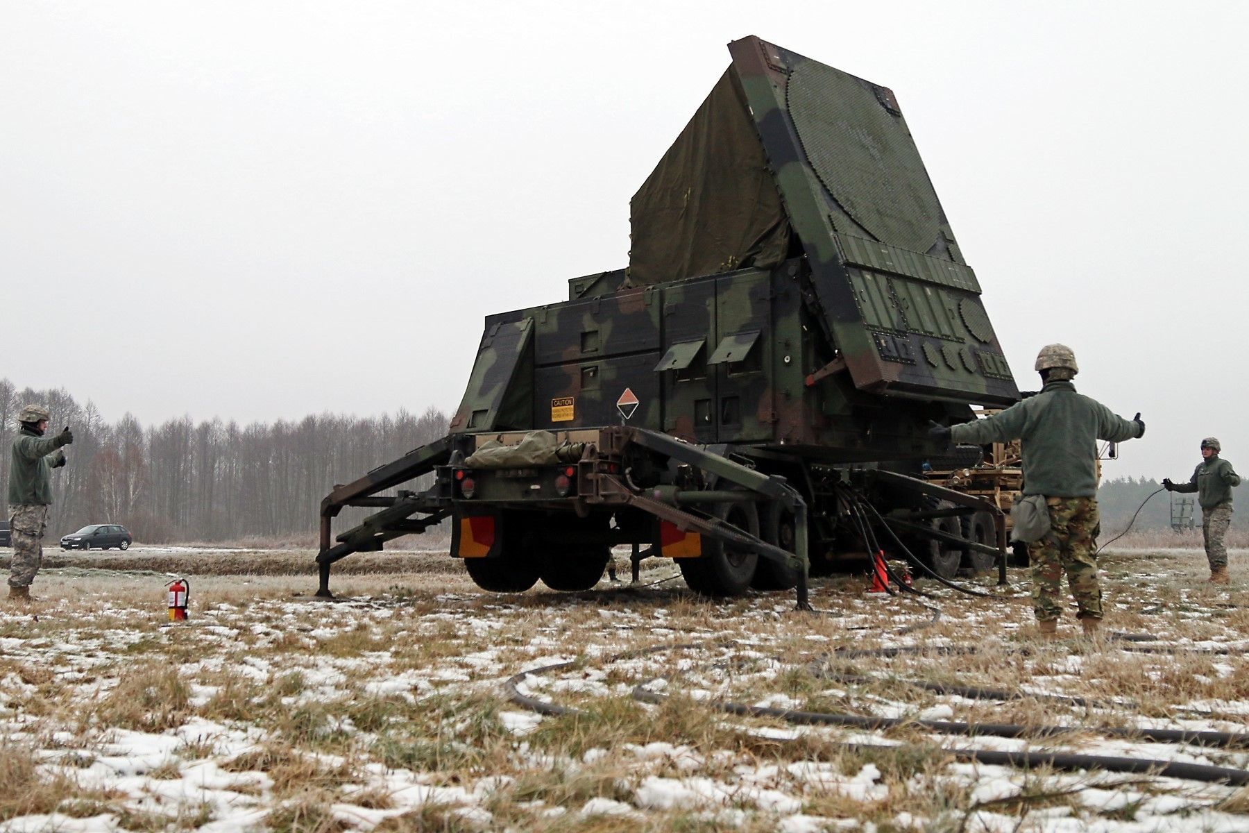 Soldiers assigned to A Battery, 5th Battalion, 7th Air Defense Artillery Brigade signal each other the area is clear while emplacing the Patriot radar set during Panther Assurance, an interoperability deployment readiness exercise, Jan. 15, at Skwierzyna, Poland. This exercise meant to demonstrate 5-7 ADA’s